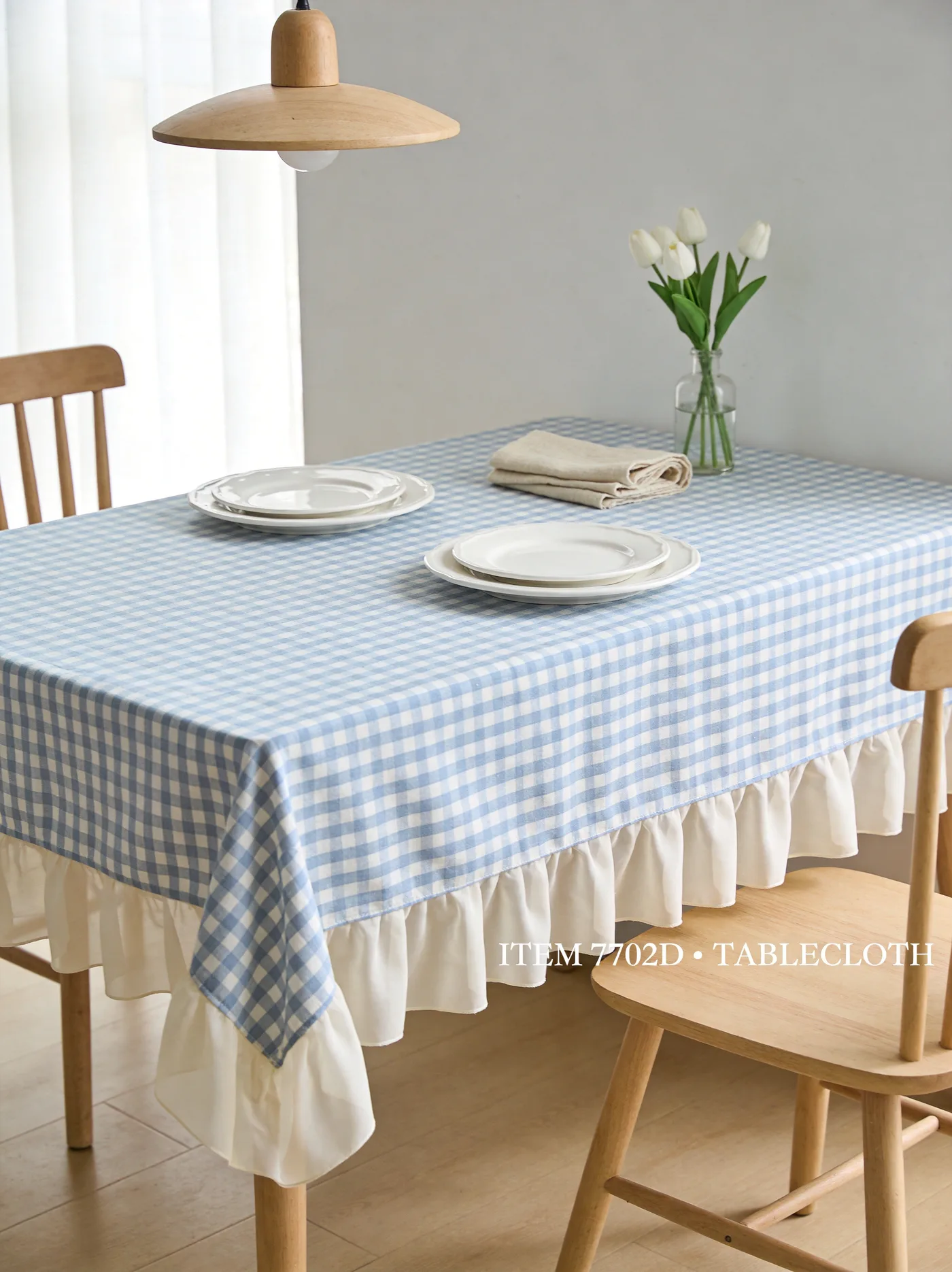Medium check gingham tablecloth with white ruffle trim in a dining scene